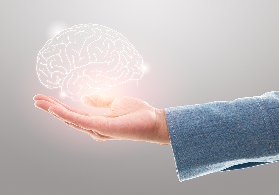 GettyImages-1321083501 A hand holding out a glowing brain in the palm of someones hands.