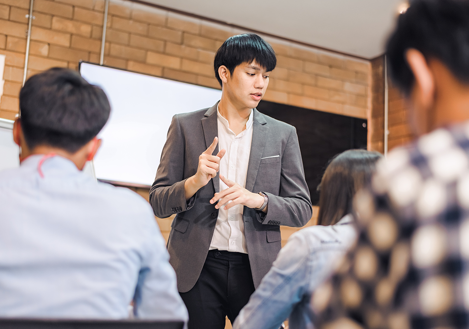 GettyImages-1338898513 A man in a suit is giving a presentation.